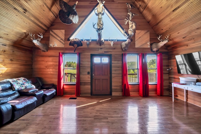 living room with wood ceiling, a healthy amount of sunlight, wood-type flooring, and wooden walls