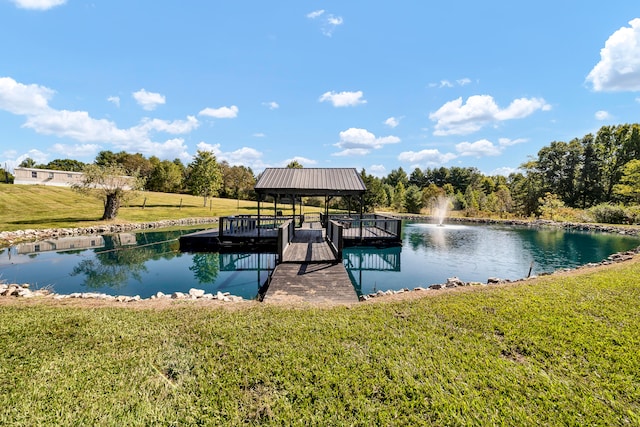 dock area with a water view, a gazebo, and a lawn