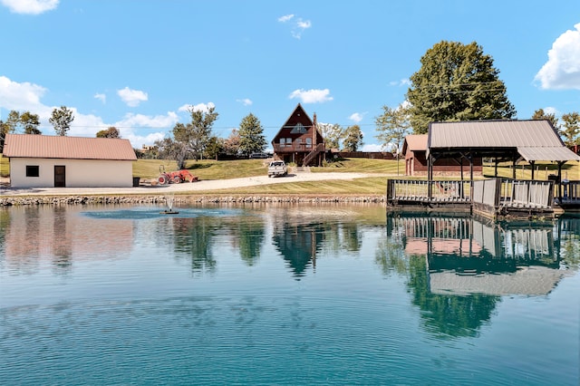 view of swimming pool with a yard and a water view