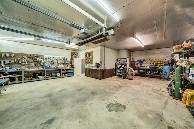 garage with a garage door opener and a workshop area