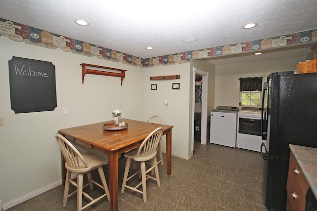 dining space with a textured ceiling and separate washer and dryer