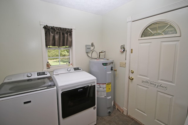 washroom featuring a textured ceiling, separate washer and dryer, and water heater