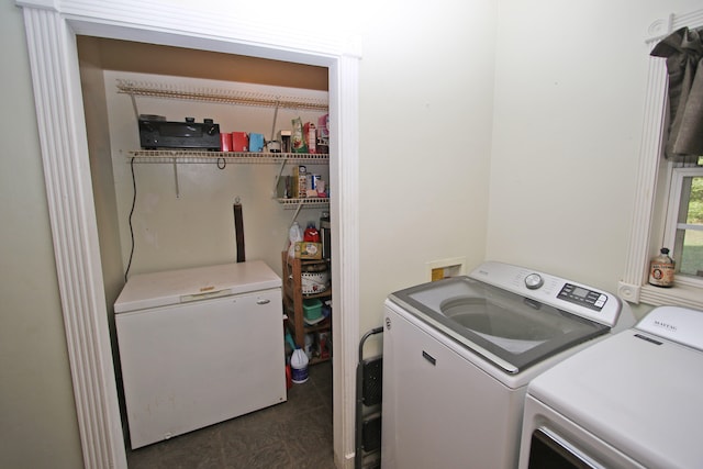 washroom with washing machine and clothes dryer