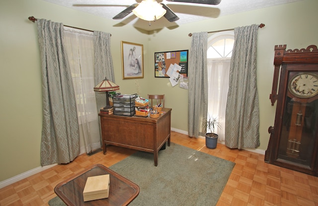 office space with parquet flooring, ceiling fan, and a textured ceiling