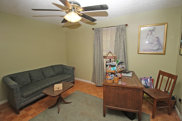 office space featuring ceiling fan, a textured ceiling, and light parquet floors