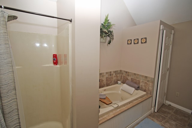 bathroom with separate shower and tub, lofted ceiling, and tile patterned flooring