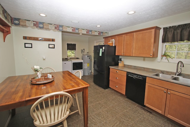 kitchen featuring black appliances, sink, independent washer and dryer, a textured ceiling, and water heater