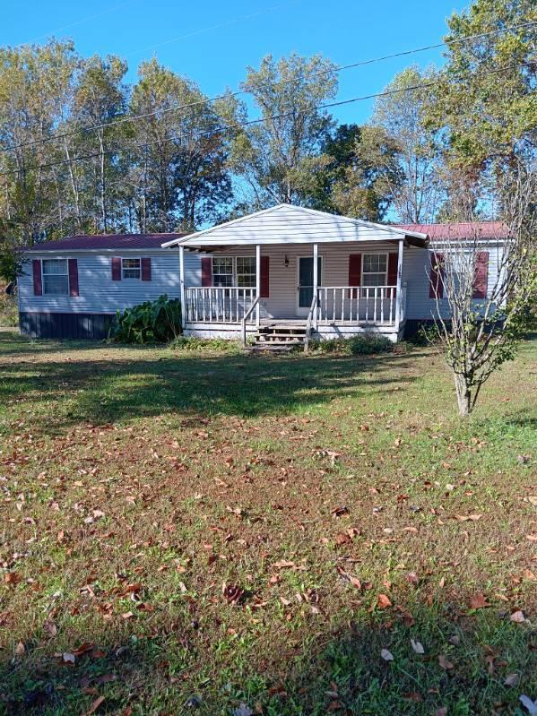 view of front facade featuring a front lawn and covered porch