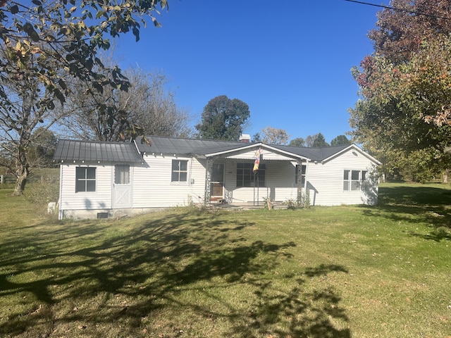 rear view of property featuring a yard