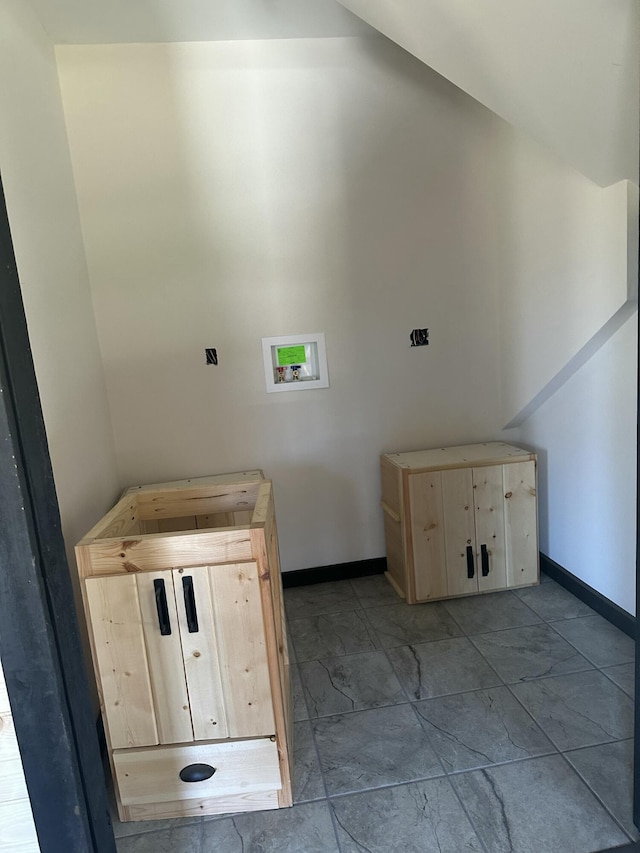 interior space featuring laundry area, baseboards, washer hookup, and marble finish floor