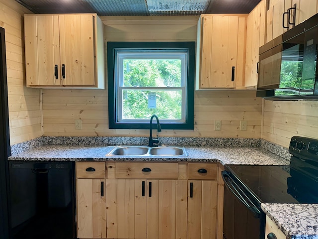 409 Freeman Branch Rd, East Bernstadt, KY 40729 - kitchen featuring black appliances, a sink, light brown cabinets, wooden walls, and light stone counters