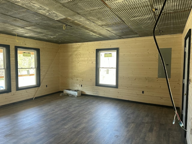 unfurnished room featuring wood finished floors and electric panel