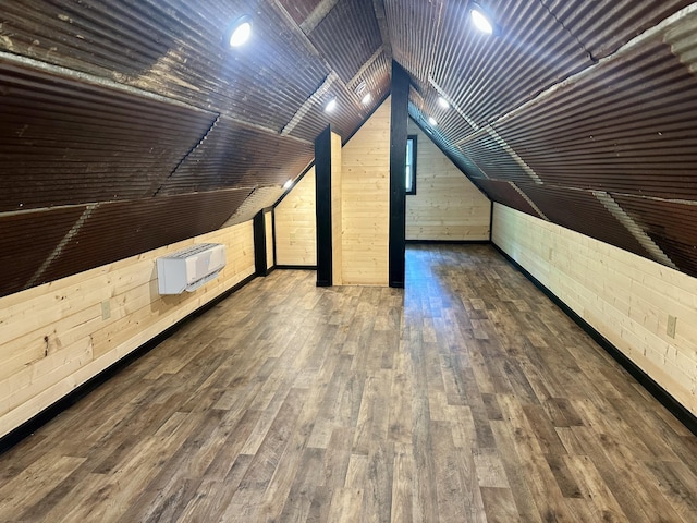 409 Freeman Branch Rd, East Bernstadt, KY 40729 - bonus room featuring wood walls, hardwood / wood-style flooring, lofted ceiling, and a wall unit AC