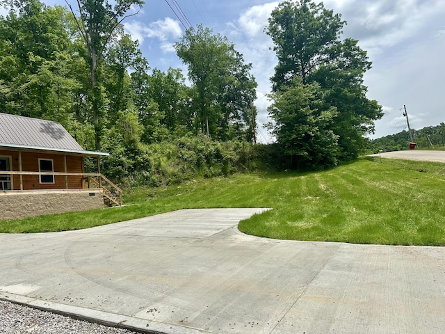409 Freeman Branch Rd, East Bernstadt, KY 40729 - view of green lawn with a porch