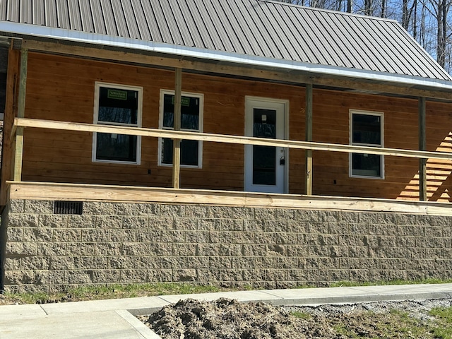 rear view of property featuring metal roof