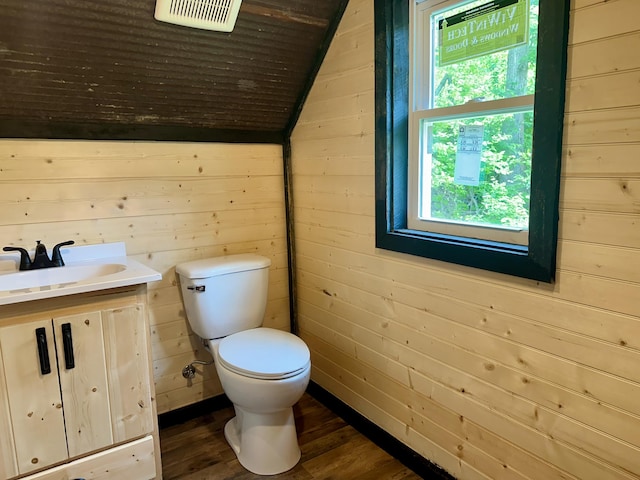 409 Freeman Branch Rd, East Bernstadt, KY 40729 - bathroom with wood finished floors, plenty of natural light, lofted ceiling, wood walls, and toilet