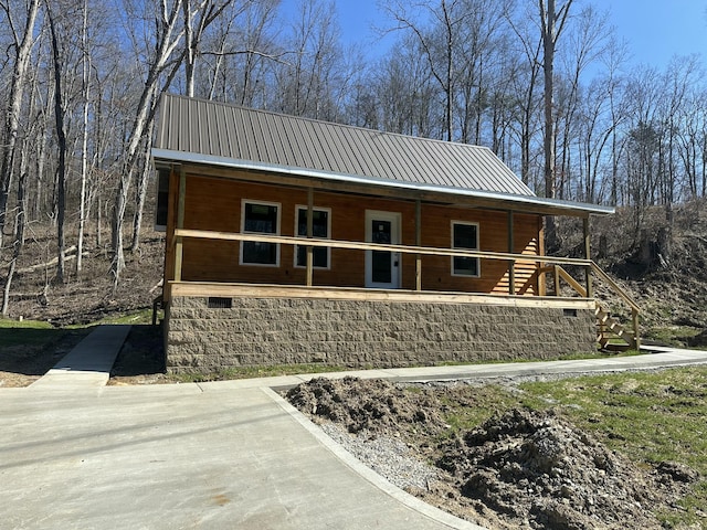 view of front facade featuring covered porch and metal roof