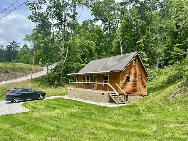 409 Freeman Branch Rd, East Bernstadt, KY 40729 - chalet / cabin featuring covered porch, a front yard, metal roof, and a view of trees