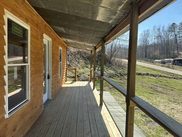 wooden terrace featuring a lawn