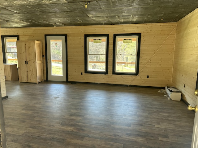 spare room featuring wooden walls and wood finished floors