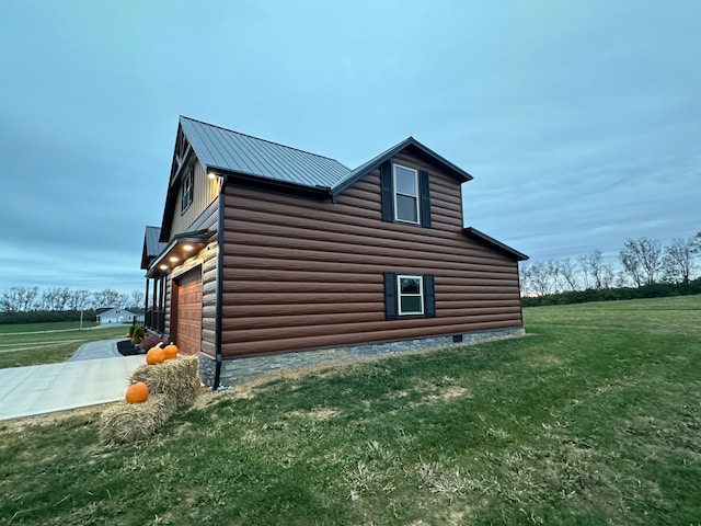 view of side of home featuring a lawn and a garage