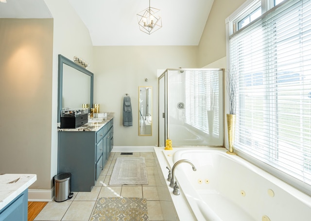 bathroom with a healthy amount of sunlight, vanity, and lofted ceiling