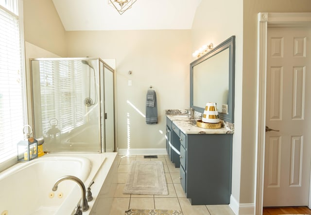 bathroom with tile patterned floors, vanity, vaulted ceiling, and separate shower and tub