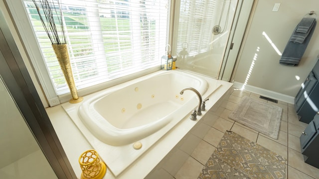 bathroom with tile patterned floors and independent shower and bath