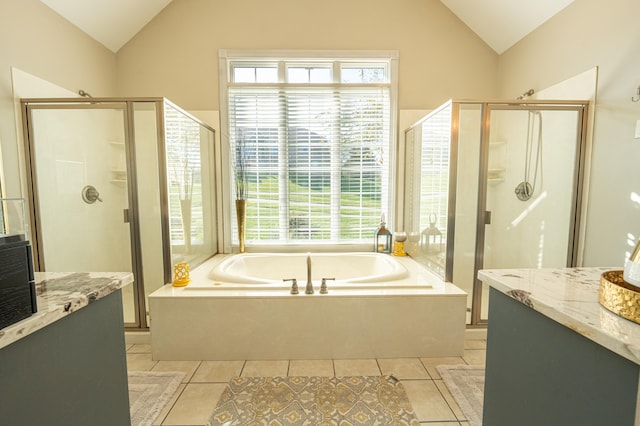 bathroom featuring plus walk in shower, vanity, tile patterned floors, and lofted ceiling