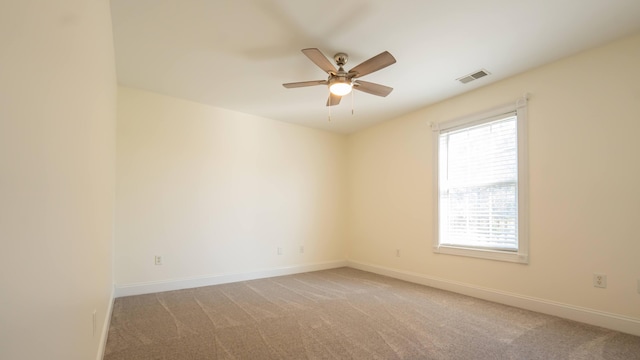 carpeted empty room with ceiling fan