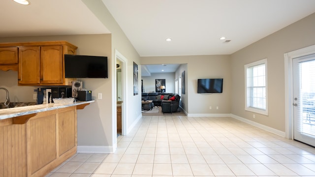 kitchen with light tile patterned floors and plenty of natural light