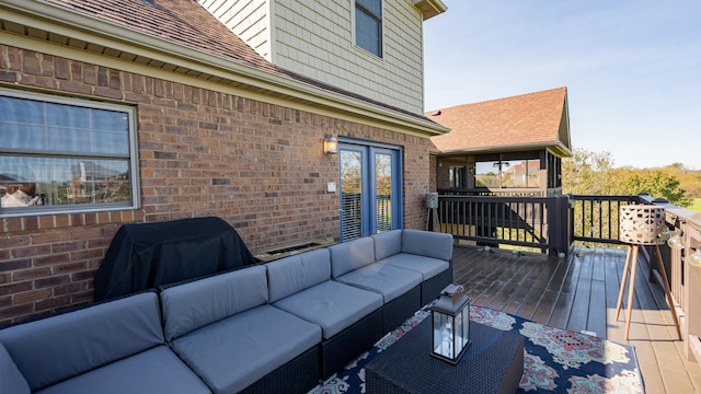 deck with outdoor lounge area and grilling area