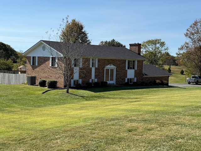 split foyer home with a front yard and central AC