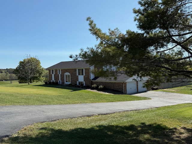 view of front facade with a front lawn and a garage