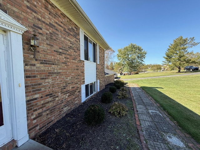 view of home's exterior with a yard