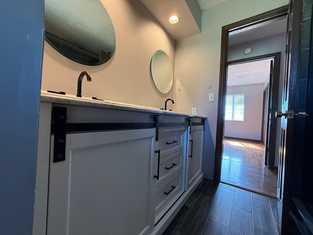 bathroom with vanity and a textured ceiling