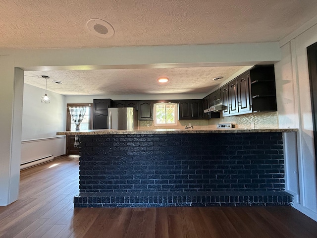 kitchen with a baseboard radiator, stainless steel fridge, a textured ceiling, and dark hardwood / wood-style flooring