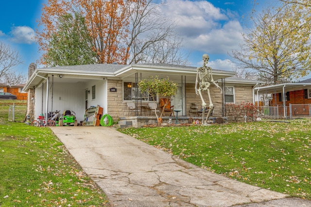 view of front of home with a carport and a front lawn