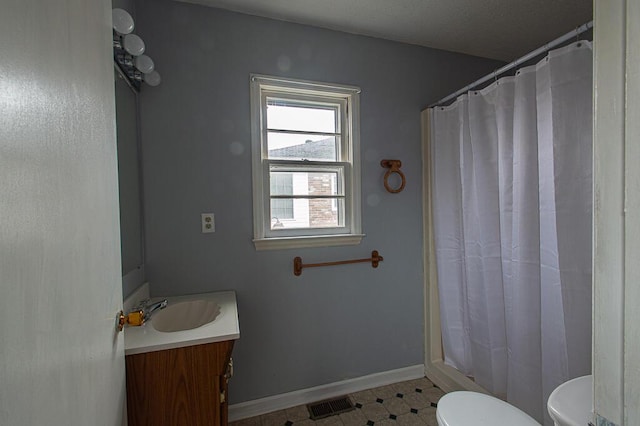 bathroom featuring vanity, curtained shower, and toilet