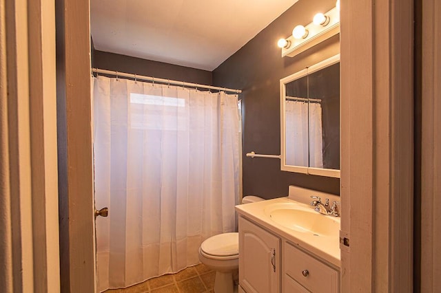 bathroom featuring tile patterned flooring, vanity, and toilet