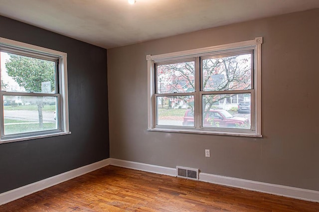 empty room with hardwood / wood-style floors