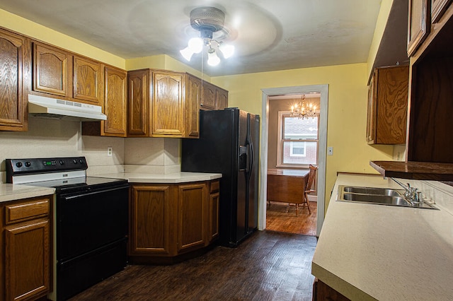 kitchen featuring ceiling fan with notable chandelier, sink, dark wood-type flooring, and black appliances