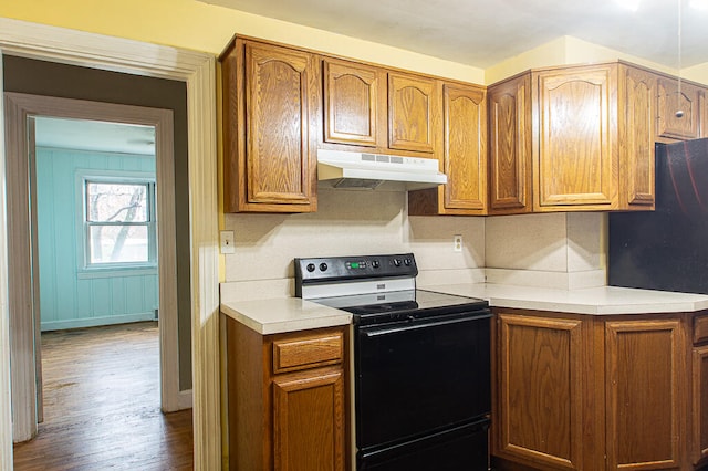 kitchen featuring hardwood / wood-style flooring and black electric range oven