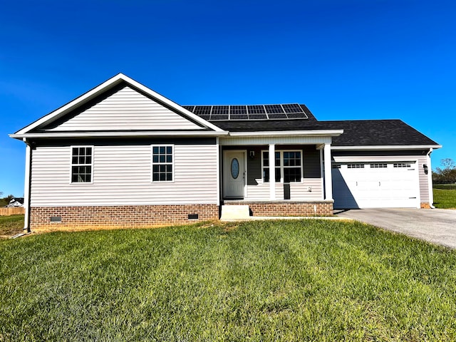 view of front facade featuring a front yard, solar panels, and a garage