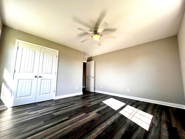 unfurnished bedroom featuring a closet, ceiling fan, and dark hardwood / wood-style flooring