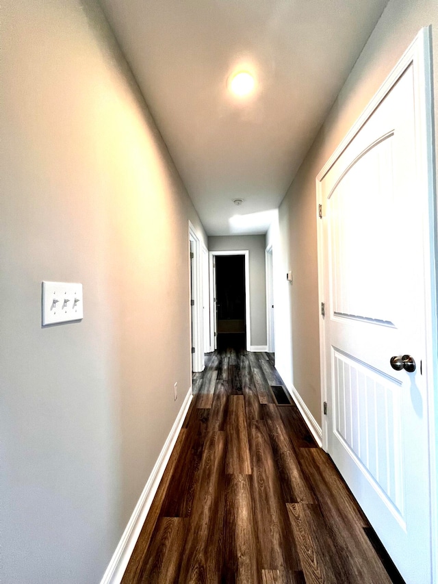 corridor with dark hardwood / wood-style floors