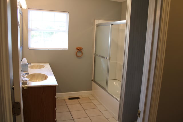 bathroom featuring shower / bath combination with glass door, vanity, and tile patterned floors