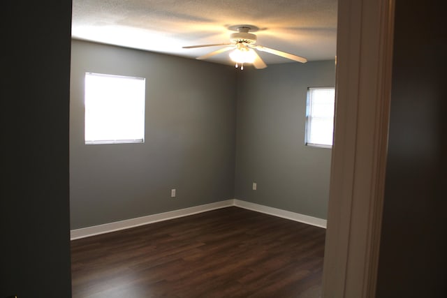 spare room with a textured ceiling, dark hardwood / wood-style flooring, and ceiling fan