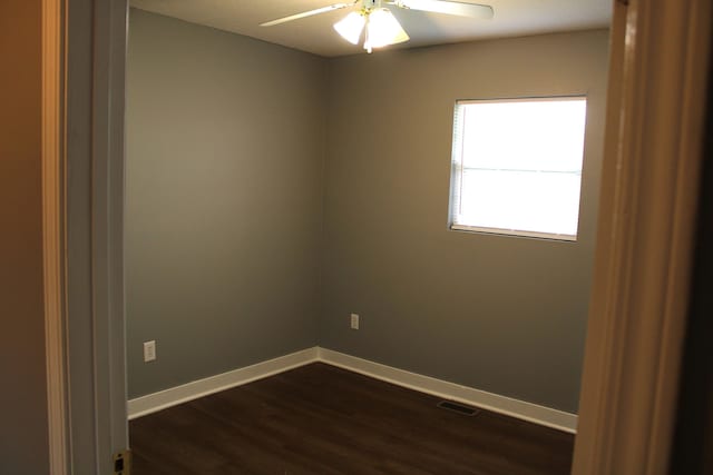 spare room featuring ceiling fan and dark hardwood / wood-style flooring