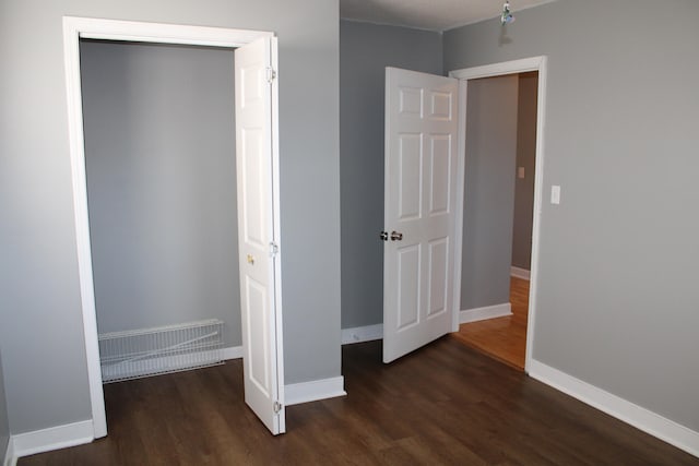 unfurnished bedroom featuring dark wood-type flooring